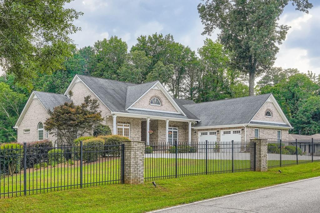 a front view of a house with a garden