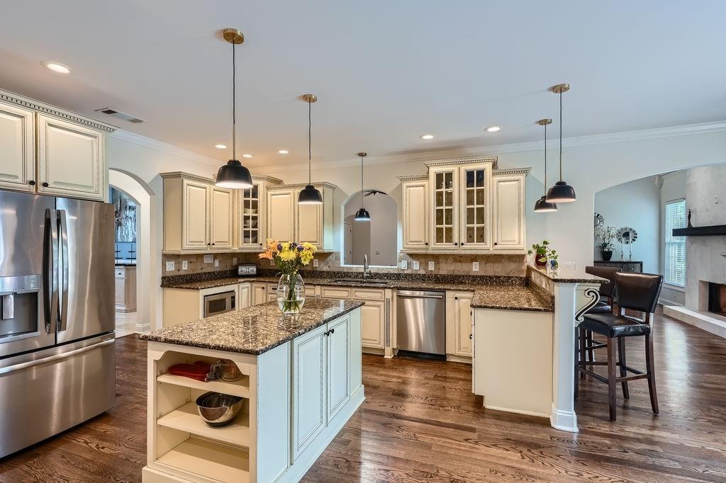 4829 Moon Road Powder Springs, GA 30127 - Photo 15 of 51 a kitchen with stainless steel appliances granite countertop a sink a stove and a refrigerator