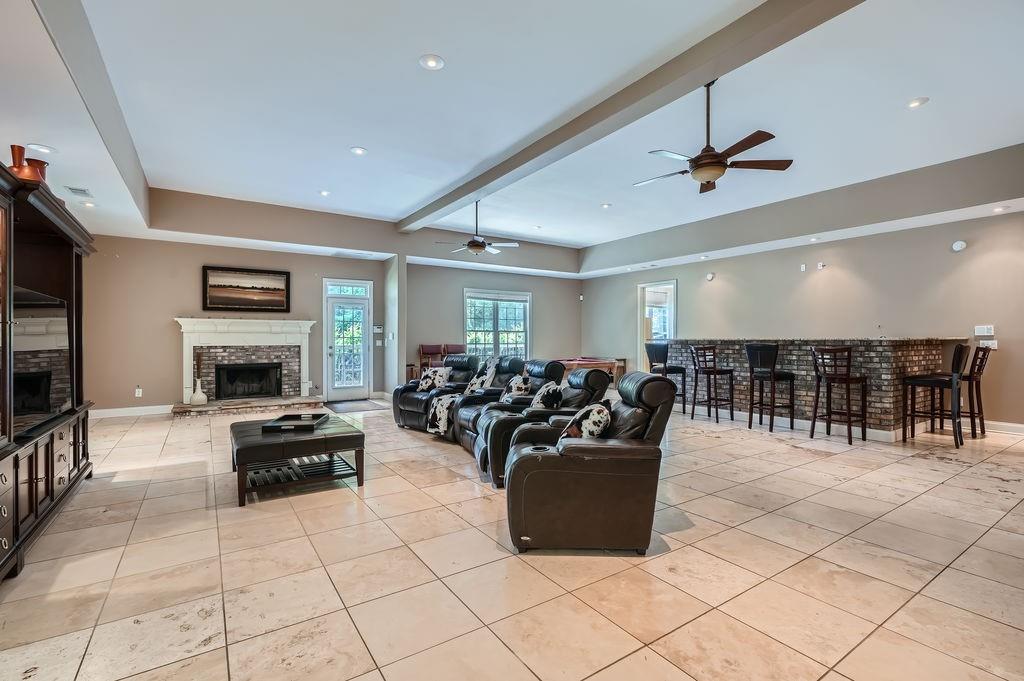 4829 Moon Road Powder Springs, GA 30127 - Photo 35 of 51 a living room with furniture gym equipment and a fireplace