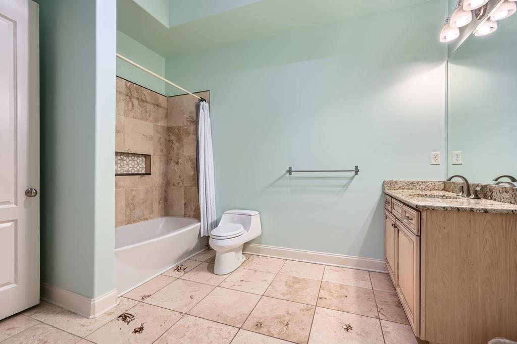 4829 Moon Road Powder Springs, GA 30127 - Photo 39 of 51 a bathroom with a granite countertop sink toilet and shower