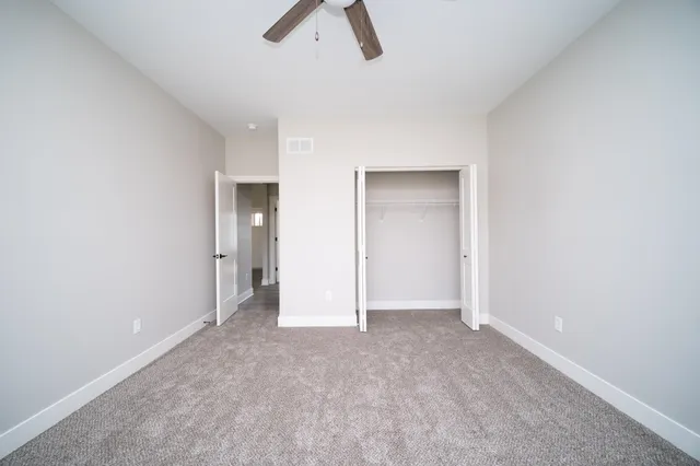 an empty room with view and closet