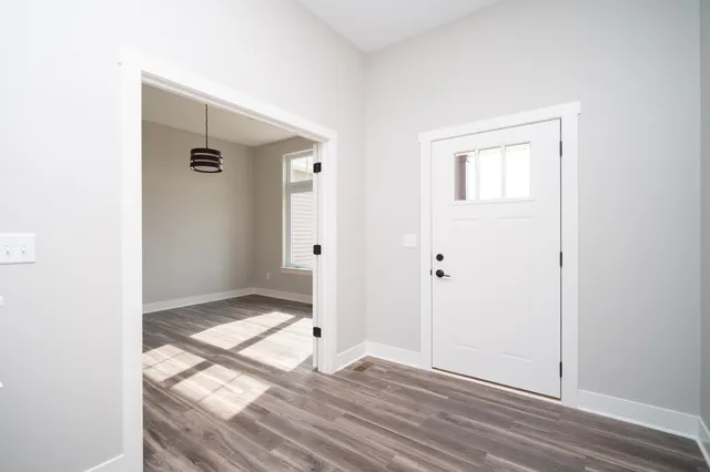 an empty room with wooden floor and closet