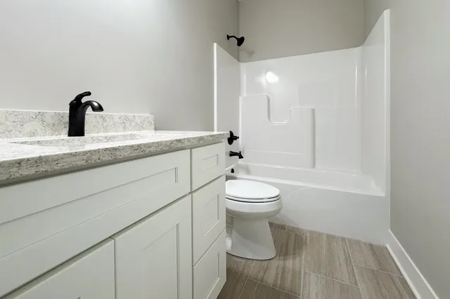a bathroom with a toilet a sink and bathtub