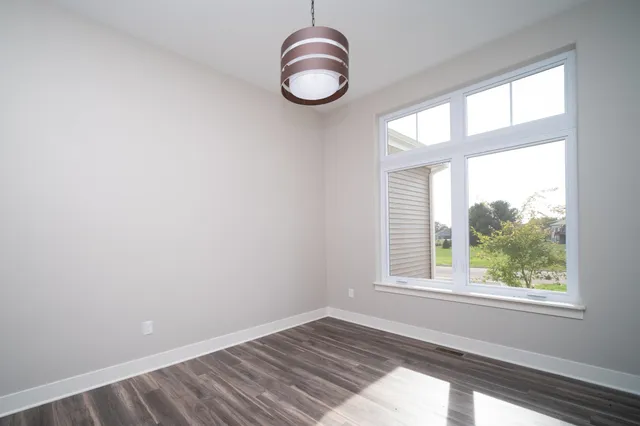 an empty room with windows and entrance