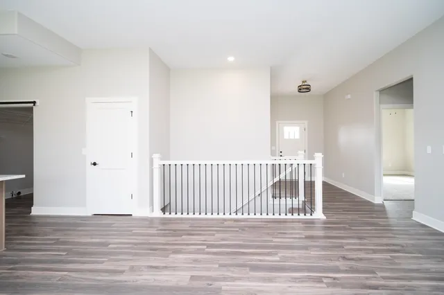 a view of a hallway with wooden floor