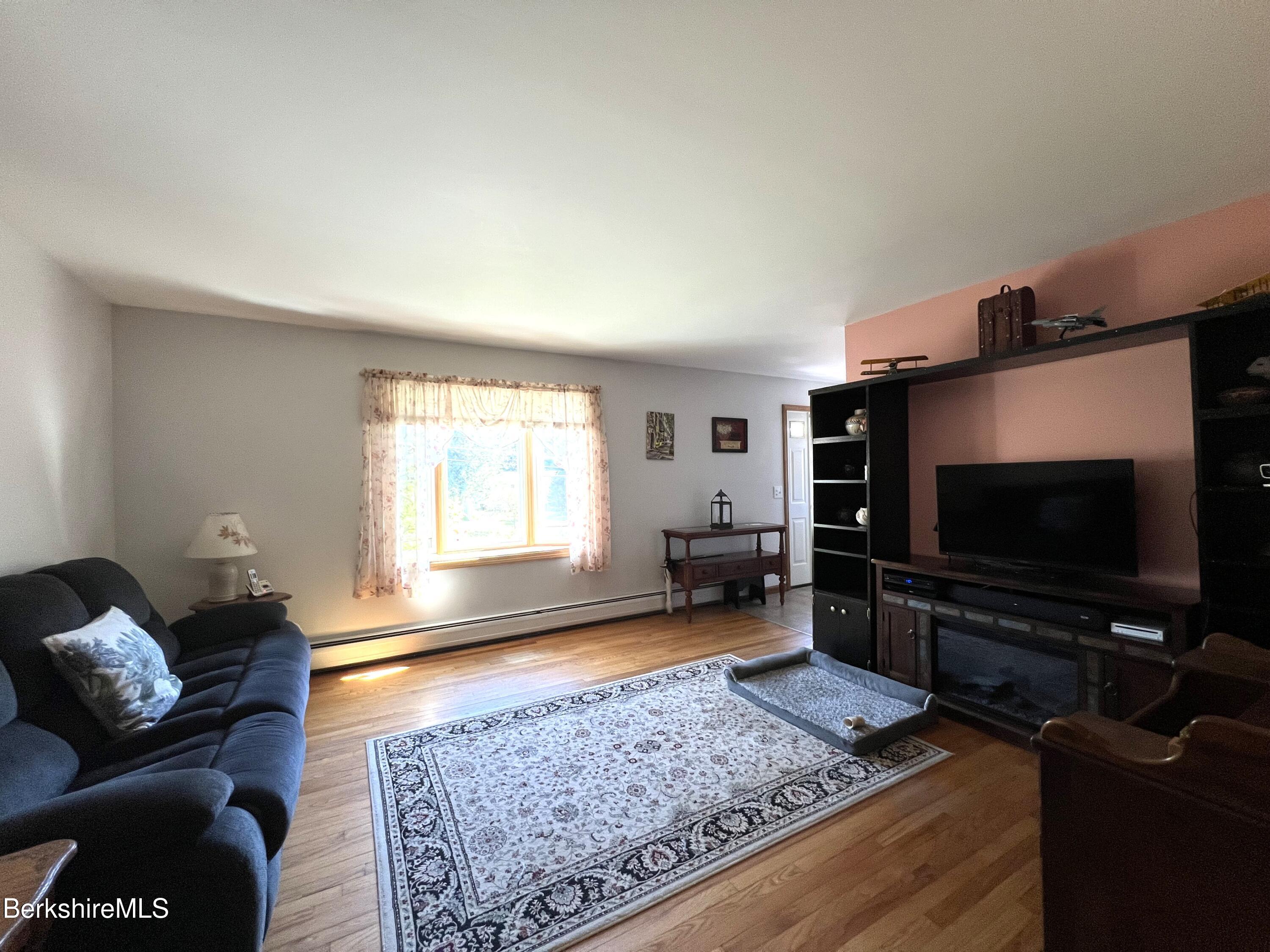 215 Partridge Road Pittsfield, MA 01201 - Photo 12 of 38 a living room with furniture and a flat screen tv