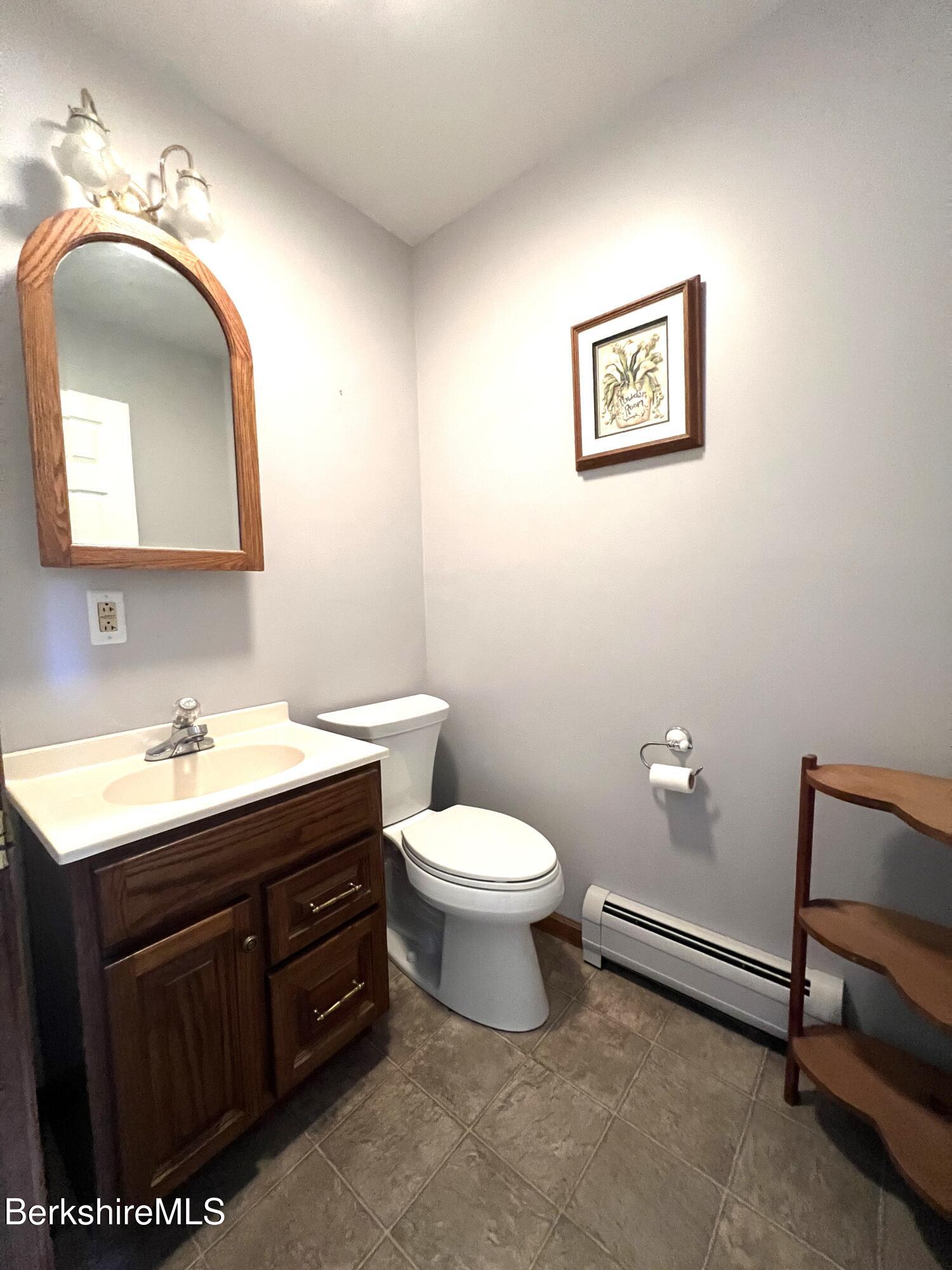 215 Partridge Road Pittsfield, MA 01201 - Photo 24 of 38 a bathroom with a toilet sink vanity and mirror
