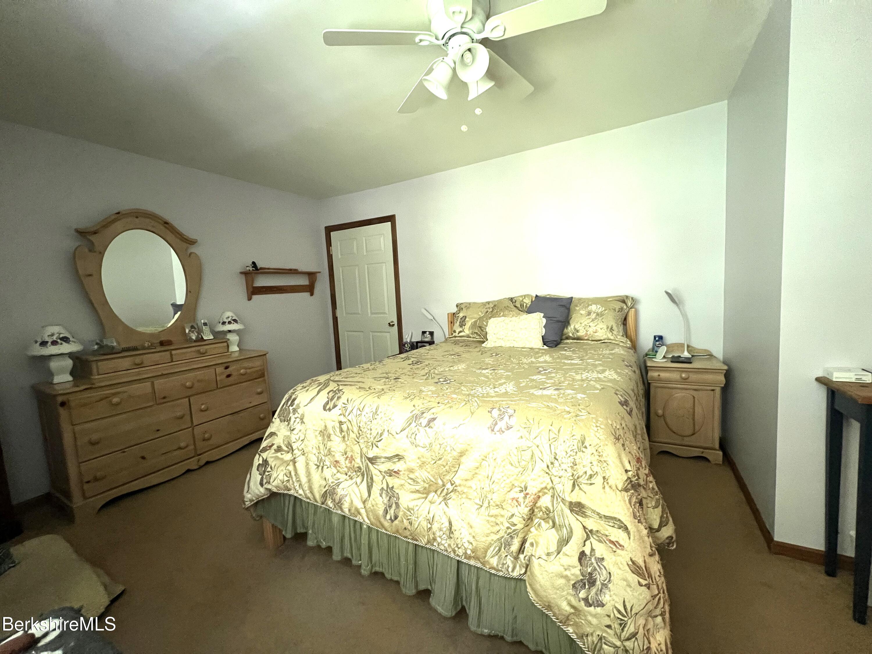 215 Partridge Road Pittsfield, MA 01201 - Photo 31 of 38 a bedroom with a bed and a dresser