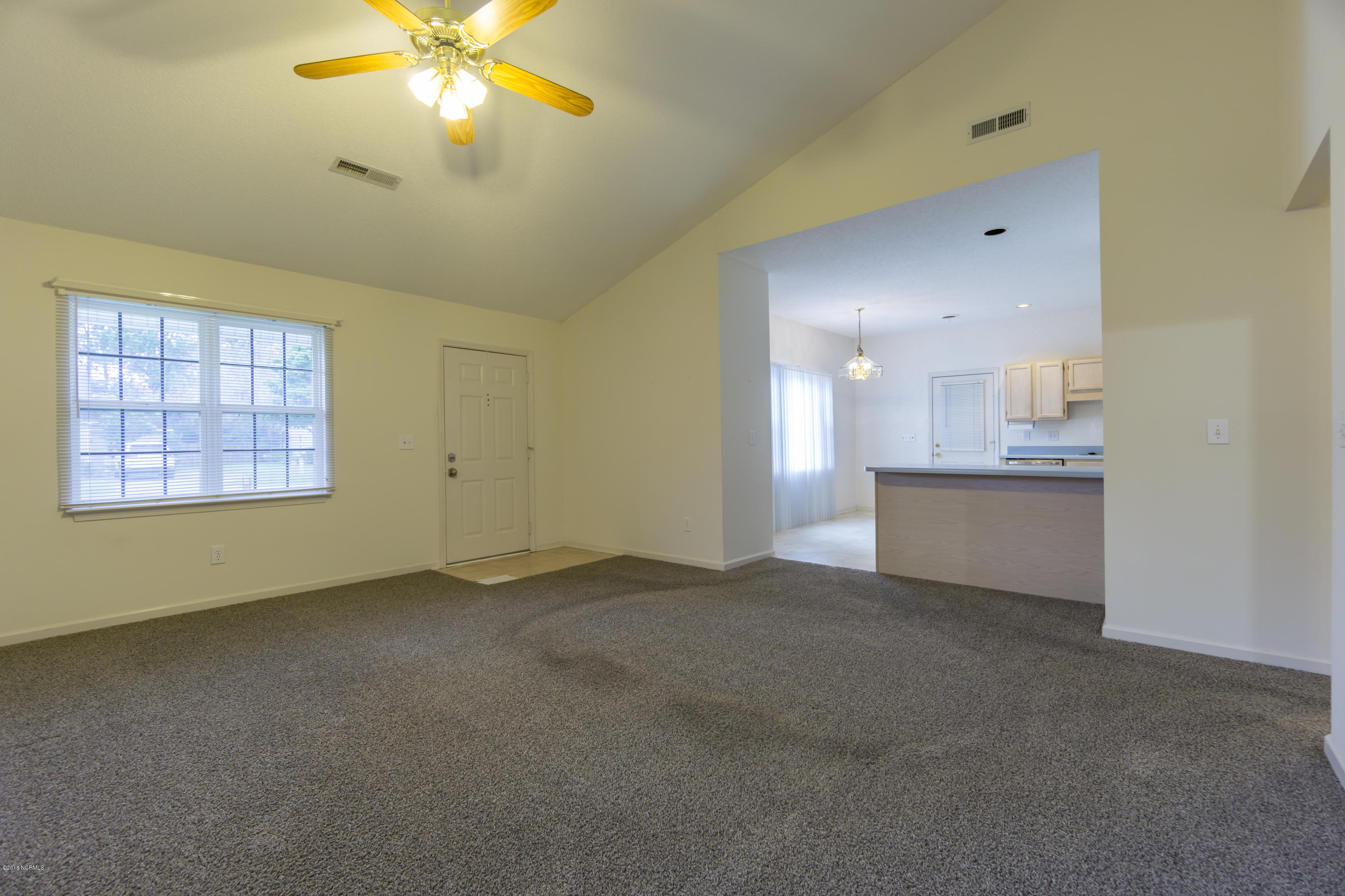2108 White Road Wilmington, NC 28411 - Photo 4 of 21 Open plan. Looking from den, over bar into the kitchen which leads out to the one car garage
