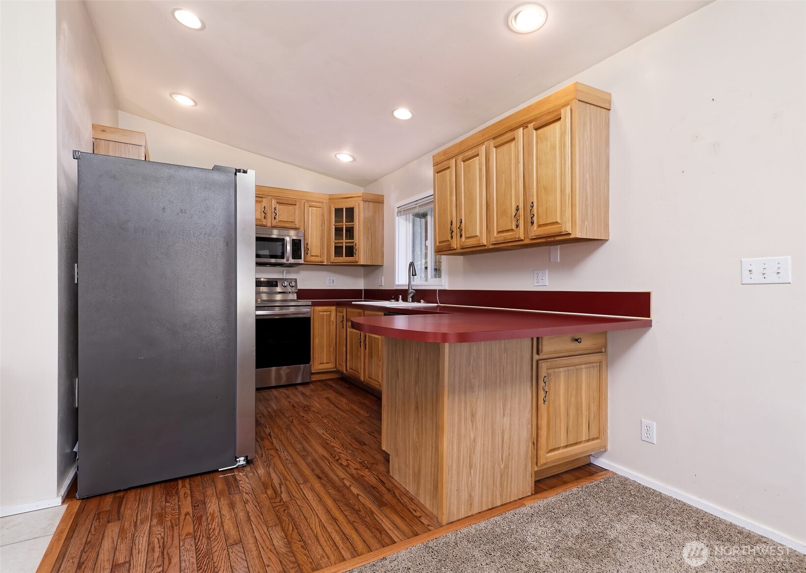 30 Brook Place Tahuya, WA 98588 - Photo 29 of 40 a kitchen with stainless steel appliances granite countertop a refrigerator a sink a stove and oven with wooden floors
