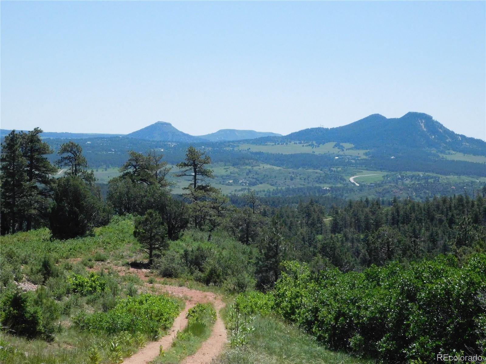5900 Pawnee Road Larkspur, CO 80118 - Photo 27 of 45 a view of a mountain range with lush green forest