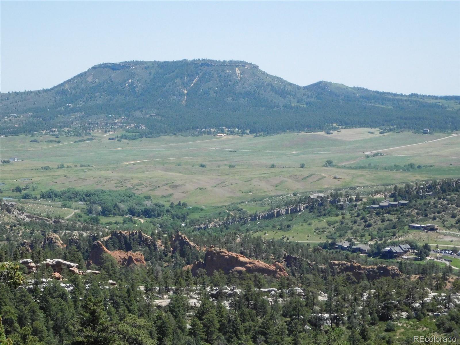 5900 Pawnee Road Larkspur, CO 80118 - Photo 31 of 45 a view of a dry field with mountains in the background