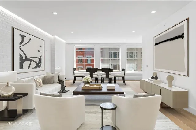 a living room with fireplace furniture and a large window