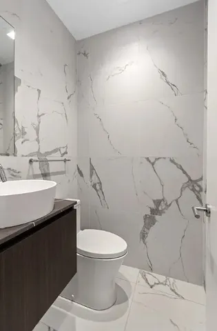 a spacious bathroom with a bathtub sink and mirror