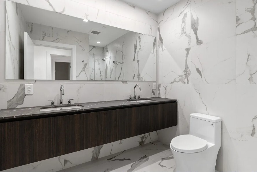 160 Franklin Street, Unit 5 Manhattan, NY 10013 - Photo 9 of 12 a bathroom with a granite countertop sink and a toilet