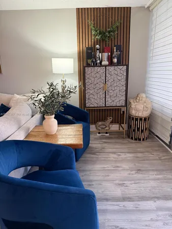 a living room with furniture and a lamp