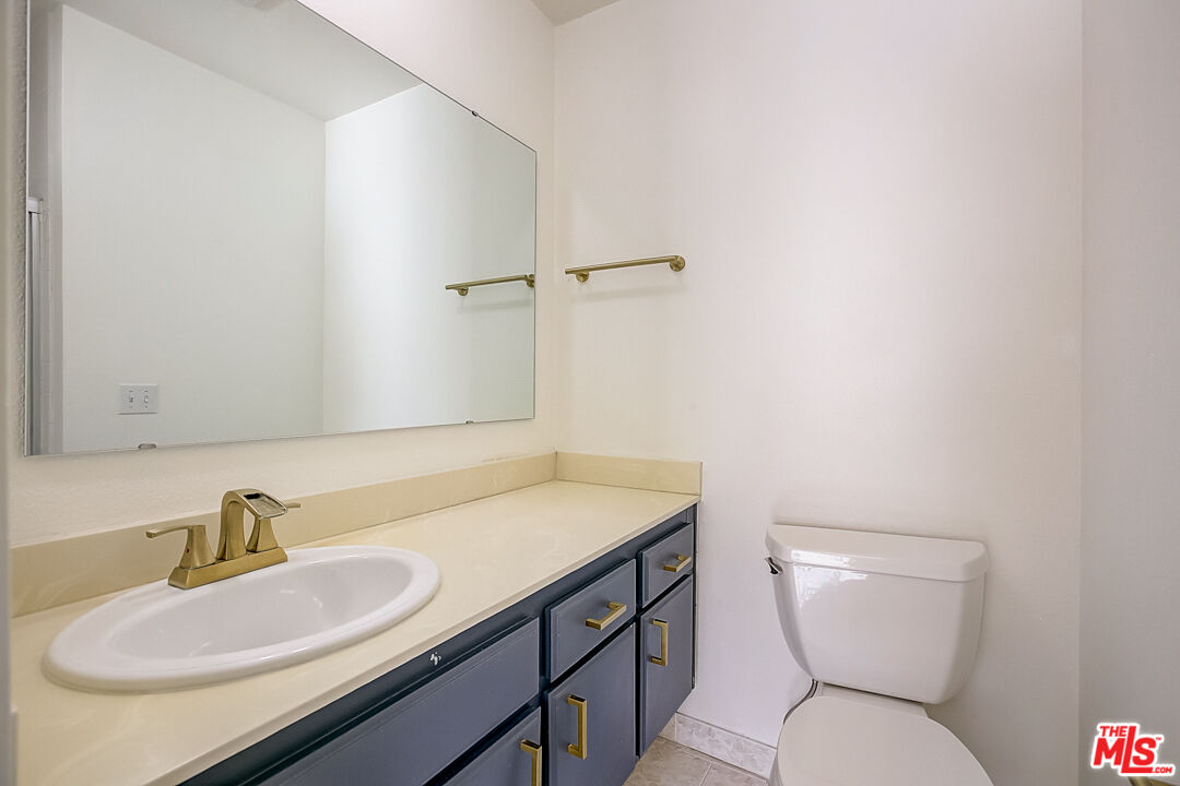 537 Spring Road, Unit 27 Moorpark, CA 93021 - Photo 24 of 30 a bathroom with a sink a toilet and a mirror