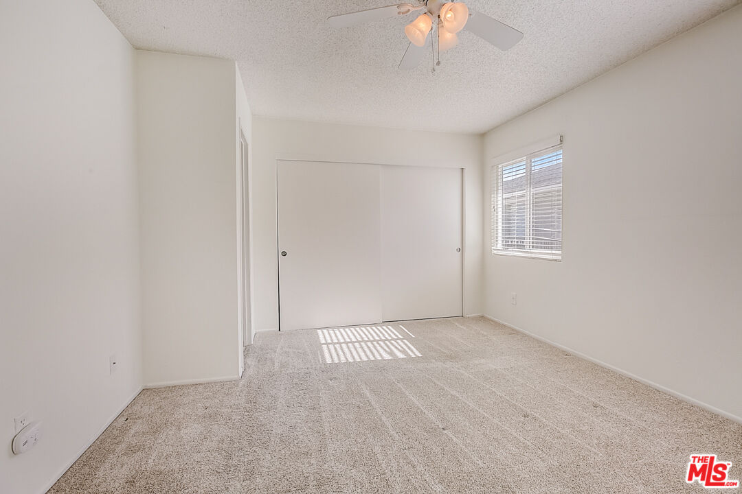 537 Spring Road, Unit 27 Moorpark, CA 93021 - Photo 7 of 30 an empty room with a chandelier fan