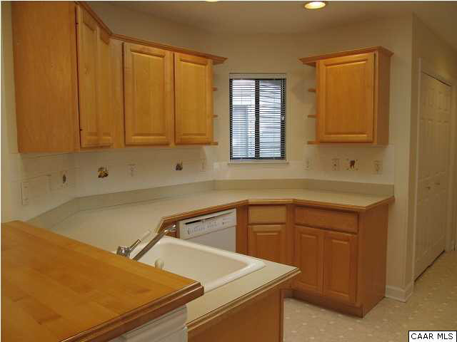 Kitchen has maple cabinets & lots of counter space.