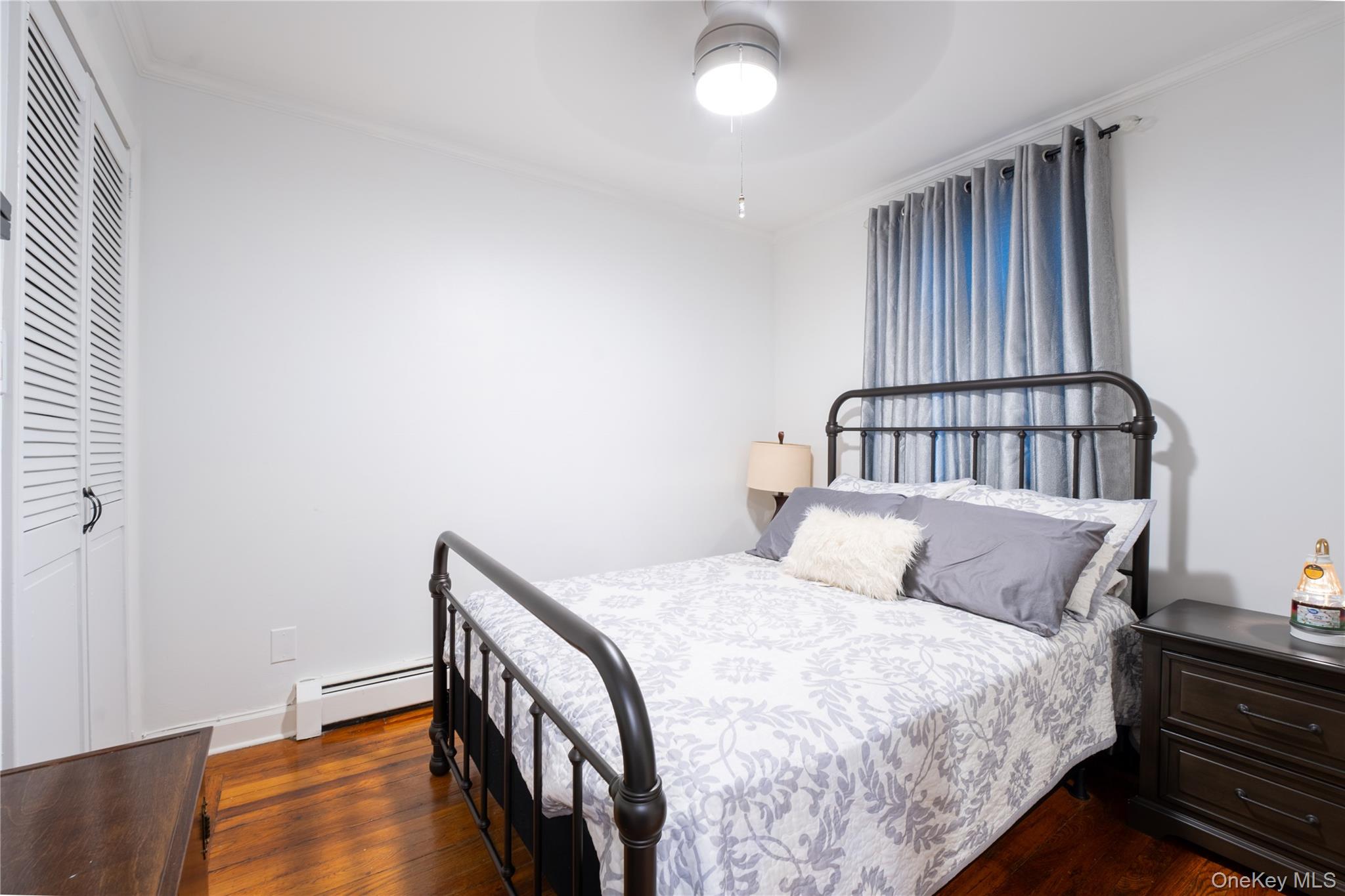 1925 Radcliff Avenue Bronx, NY 10462 - Photo 14 of 27 a bedroom with a bed and wooden floor