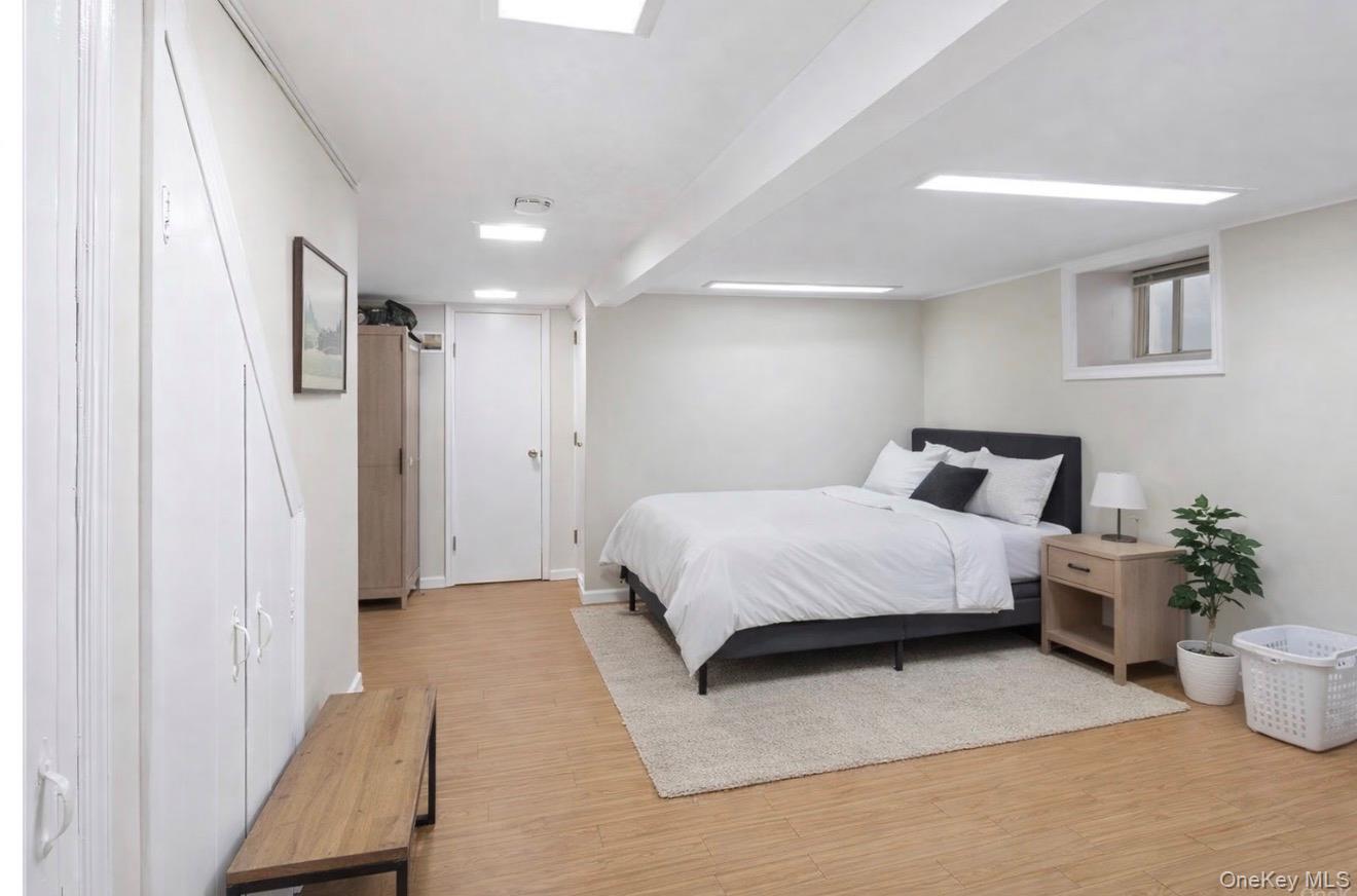 1925 Radcliff Avenue Bronx, NY 10462 - Photo 16 of 27 a spacious bedroom with a bed and a couch