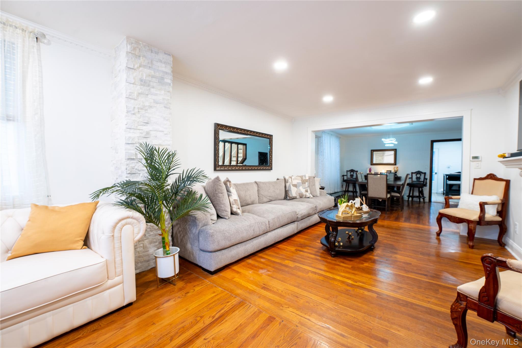 1925 Radcliff Avenue Bronx, NY 10462 - Photo 2 of 27 a living room with furniture kitchen view and a potted plant