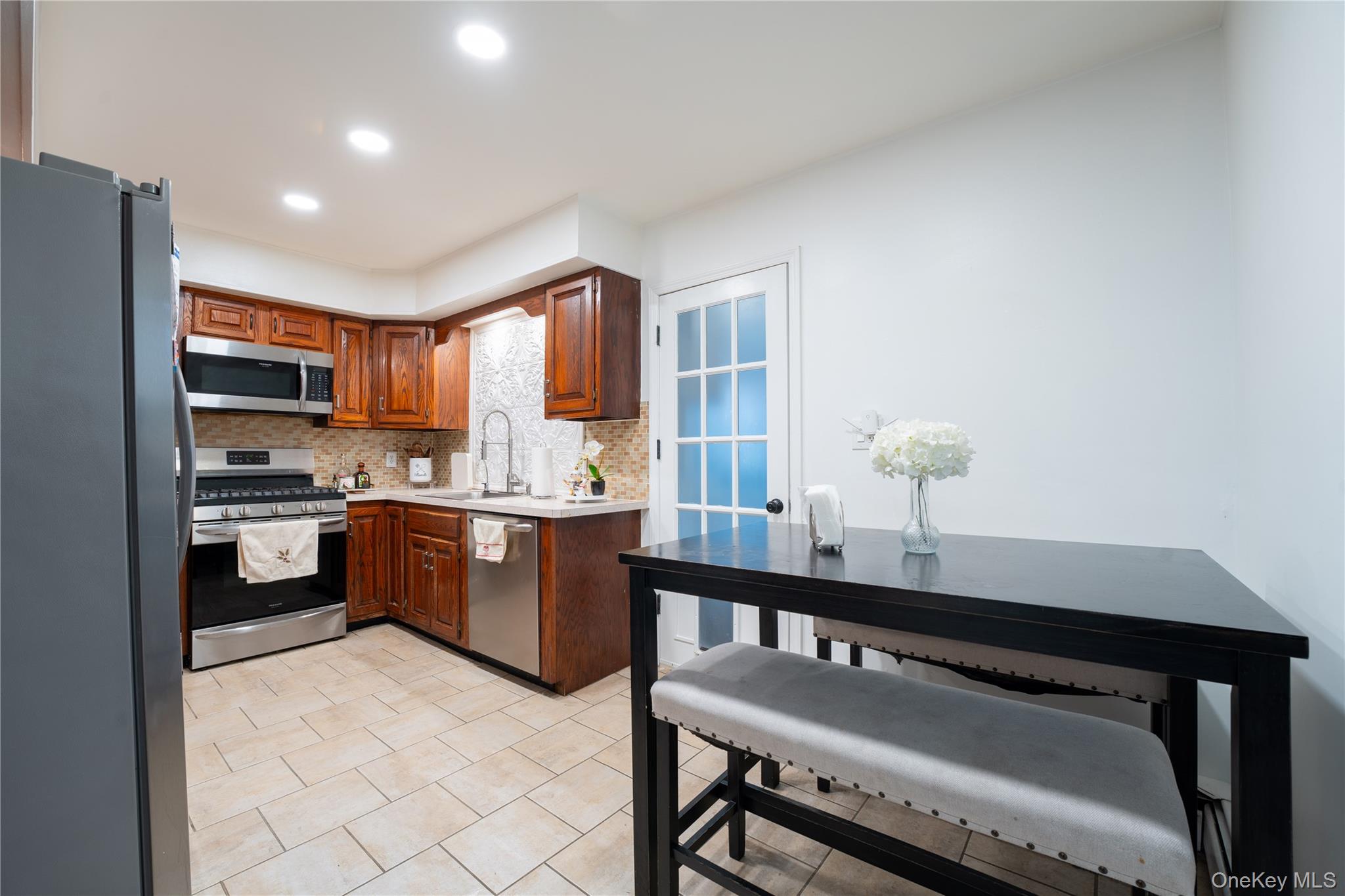 1925 Radcliff Avenue Bronx, NY 10462 - Photo 6 of 27 a kitchen with a sink refrigerator and cabinets