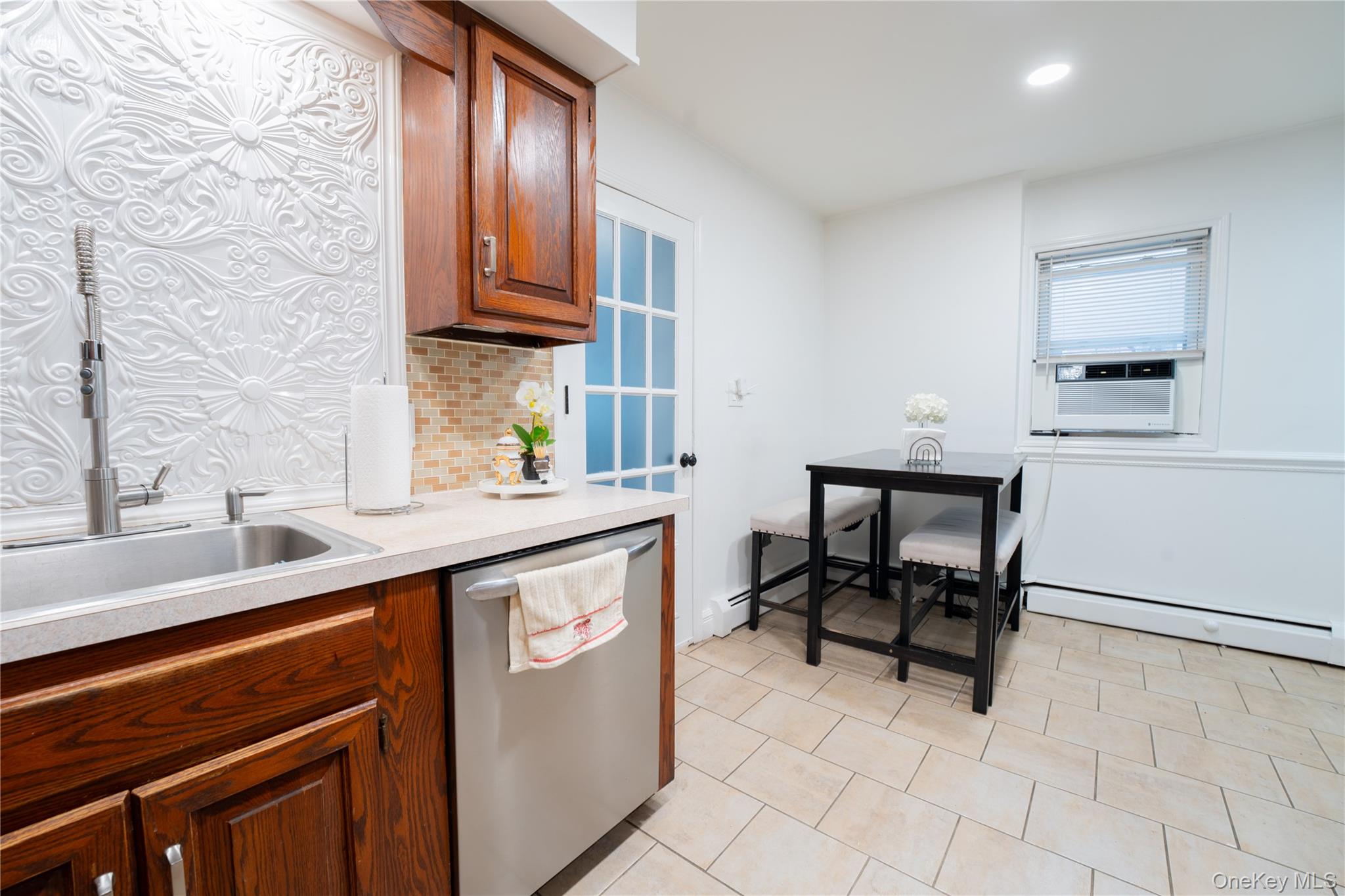 1925 Radcliff Avenue Bronx, NY 10462 - Photo 7 of 27 a kitchen with stainless steel appliances a sink stove and cabinets