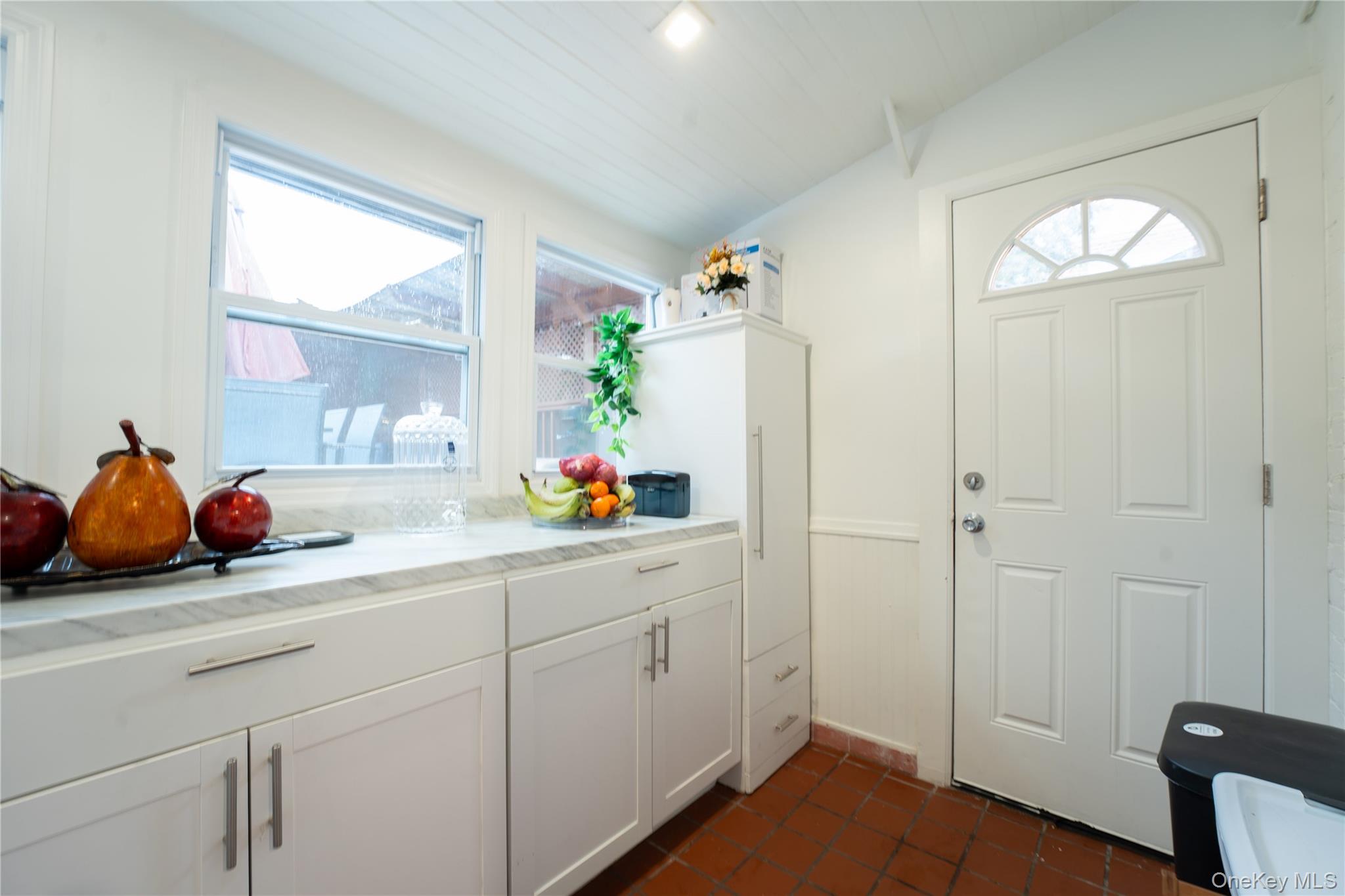 1925 Radcliff Avenue Bronx, NY 10462 - Photo 9 of 27 a kitchen with white cabinets and a window