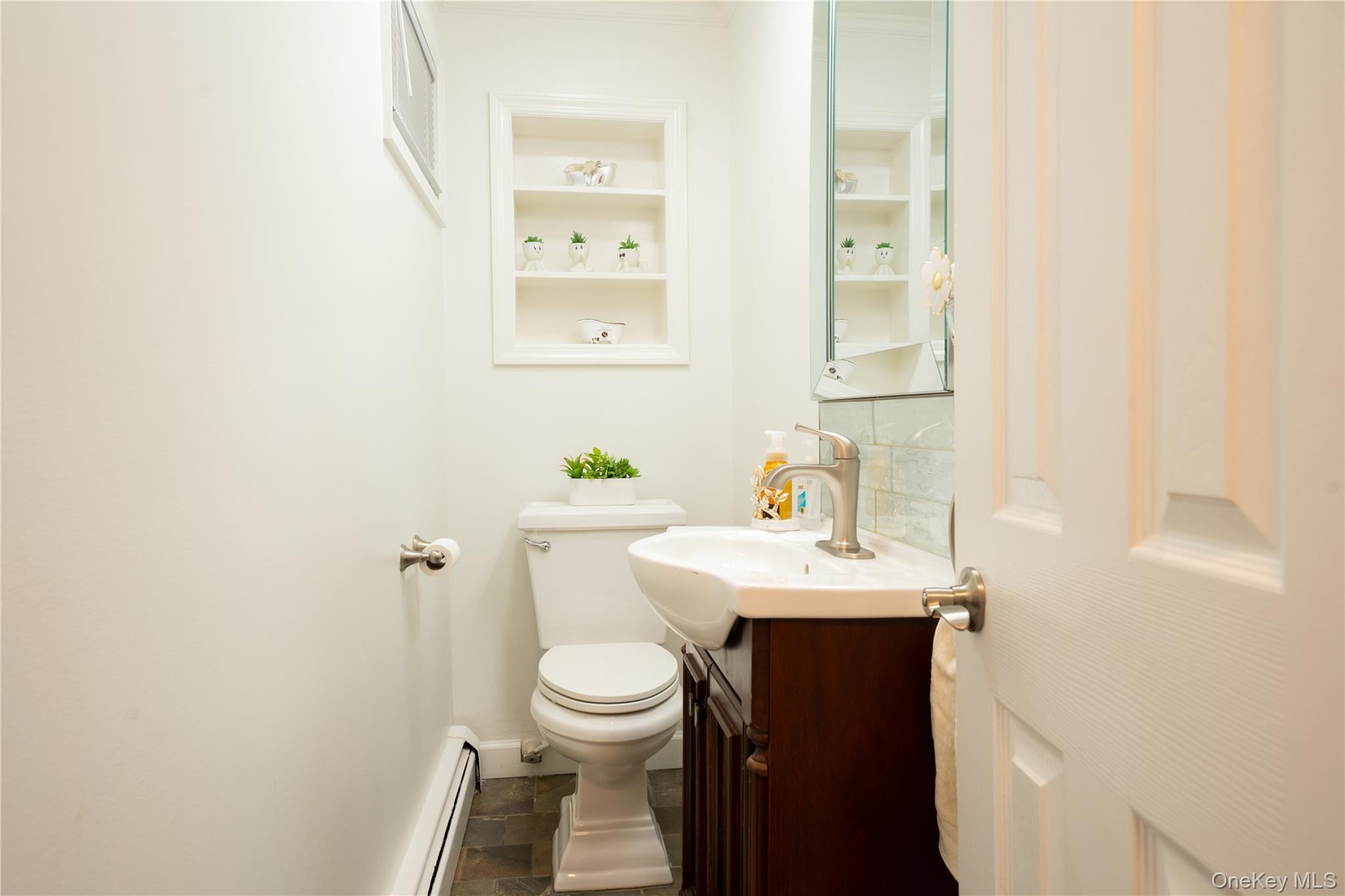 1925 Radcliff Avenue Bronx, NY 10462 - Photo 10 of 27 a bathroom with a sink toilet and mirror