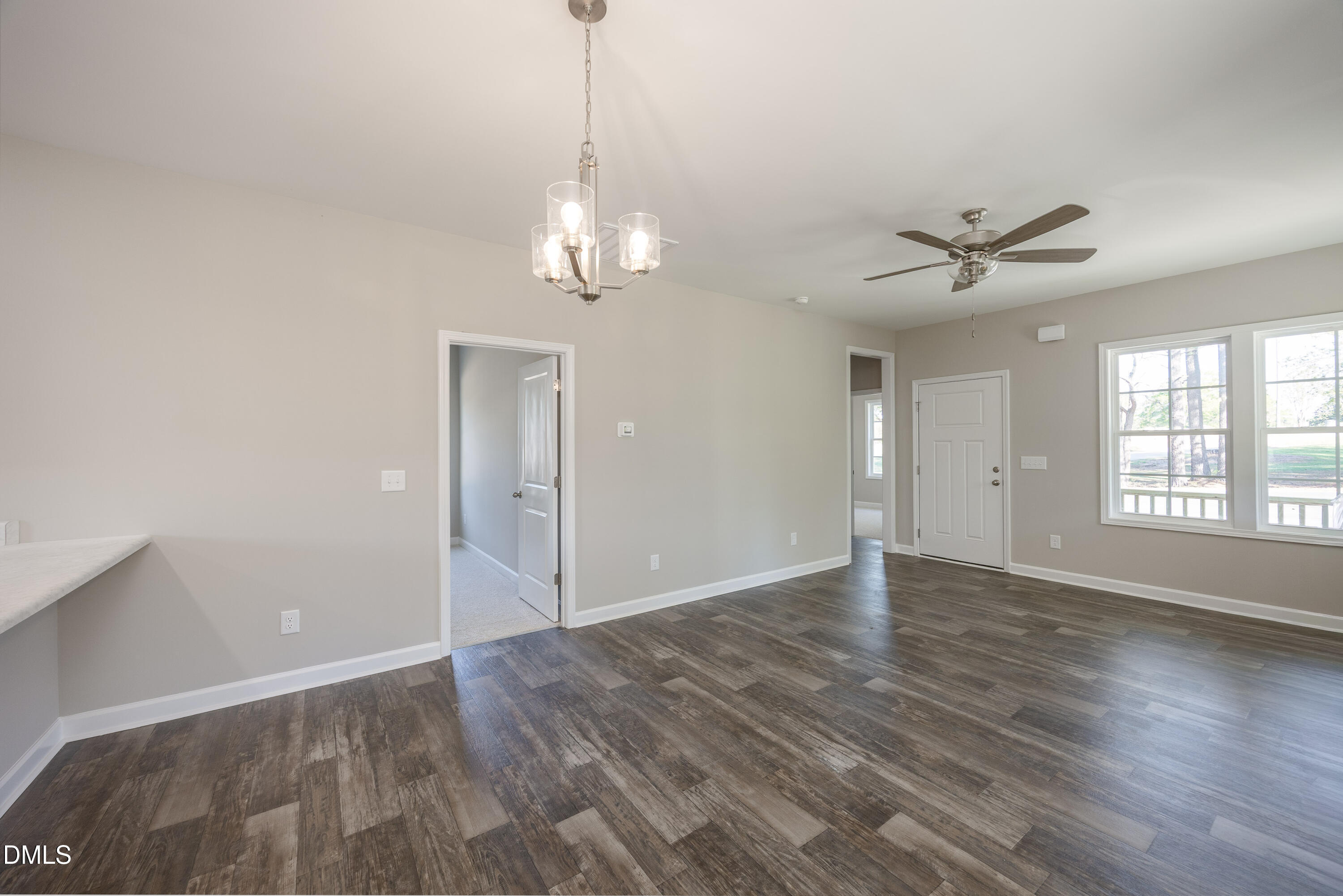 179 West Hamer Street Coats, NC 27521 - Photo 12 of 26 a view of an empty room with chandelier fan and a fireplace