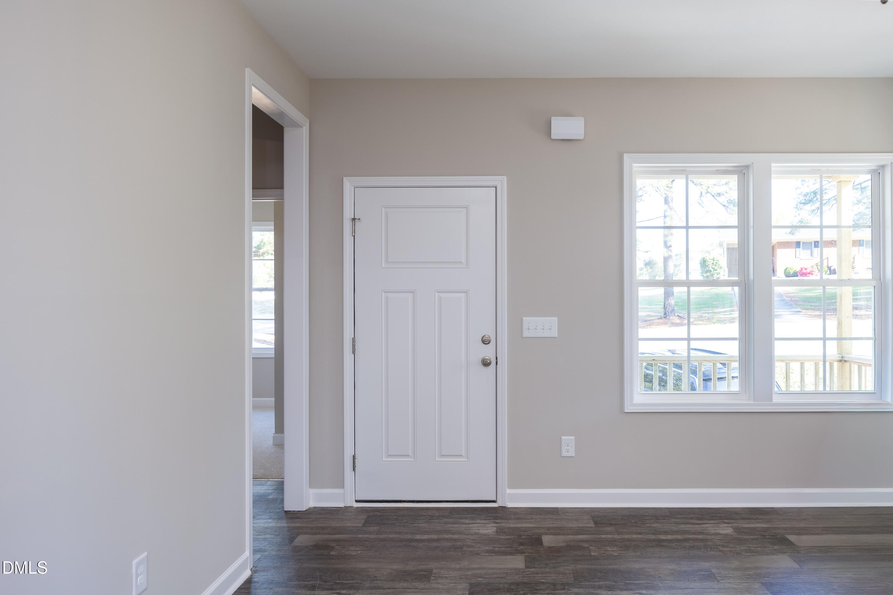 179 West Hamer Street Coats, NC 27521 - Photo 4 of 26 a view of an empty room with wooden floor and a window