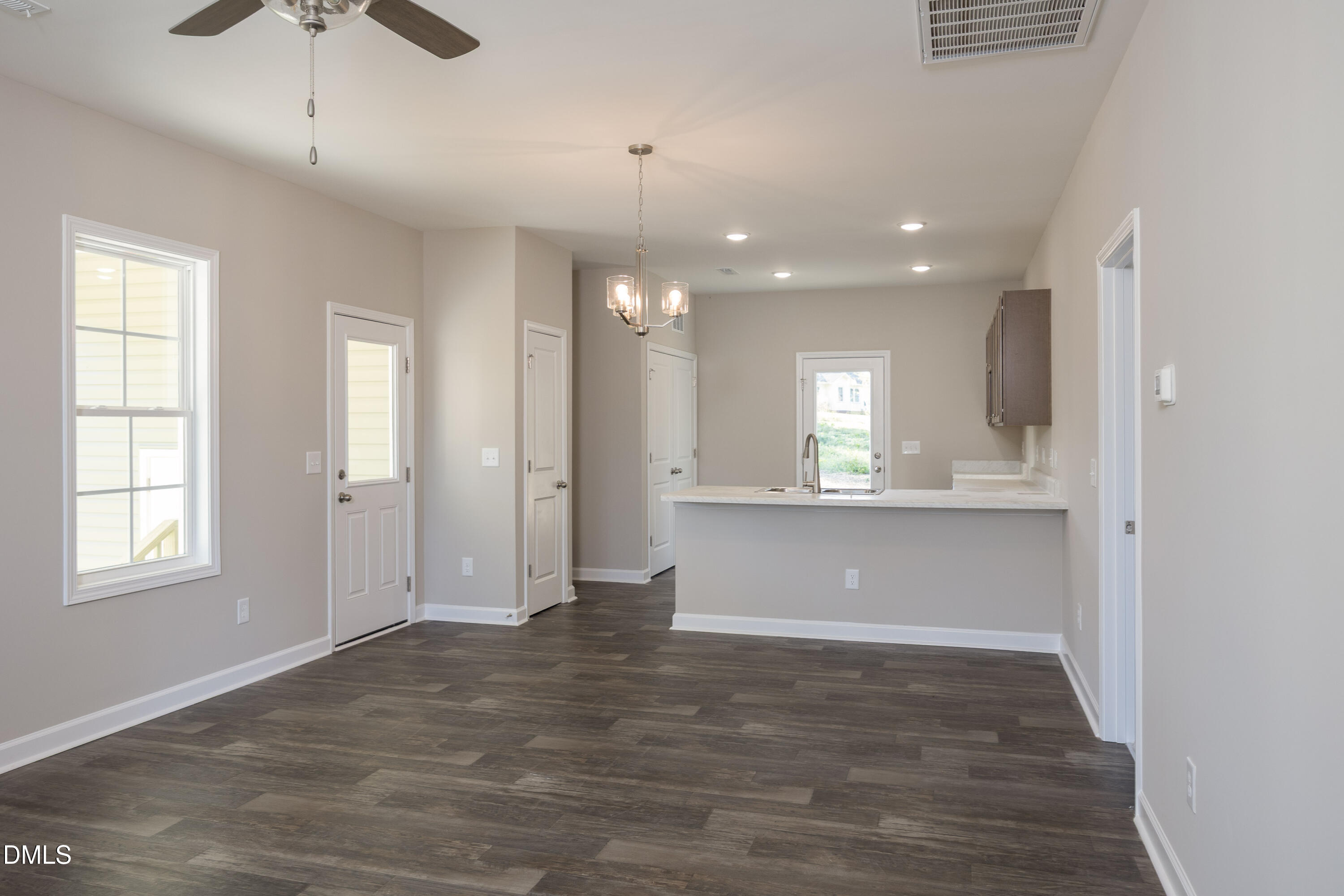 179 West Hamer Street Coats, NC 27521 - Photo 5 of 26 a view of an empty room with window and wooden floor