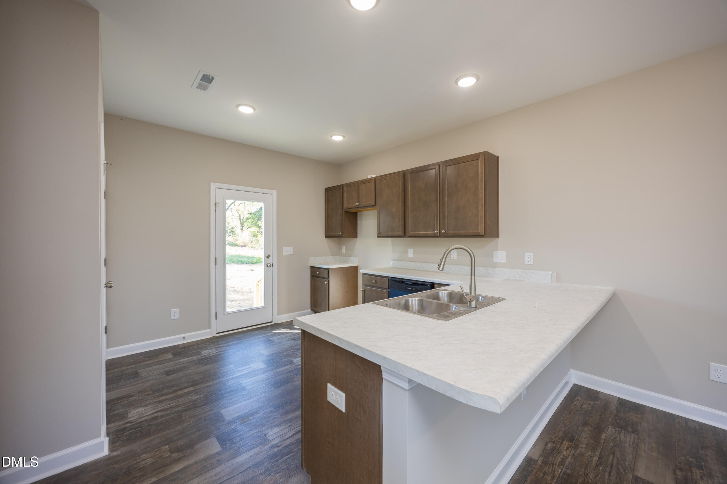 179 West Hamer Street Coats, NC 27521 - Photo 8 of 26 a kitchen with a sink a microwave and wooden floor