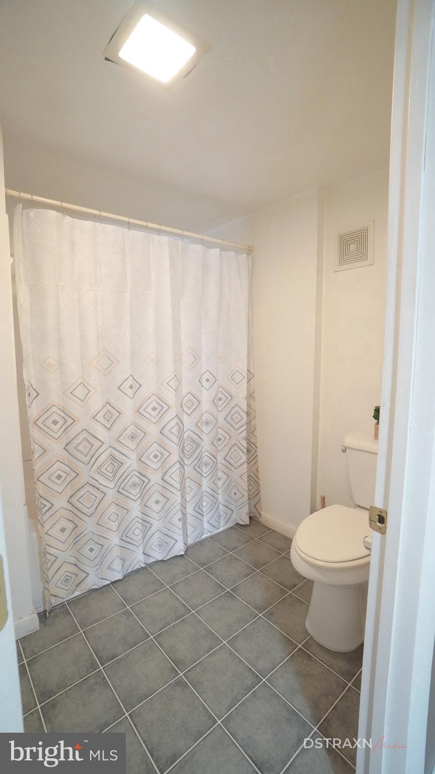 3708 Limekiln Road Sharpsburg, MD 21782 - Photo 30 of 33 a bathroom with a toilet and a shower curtain