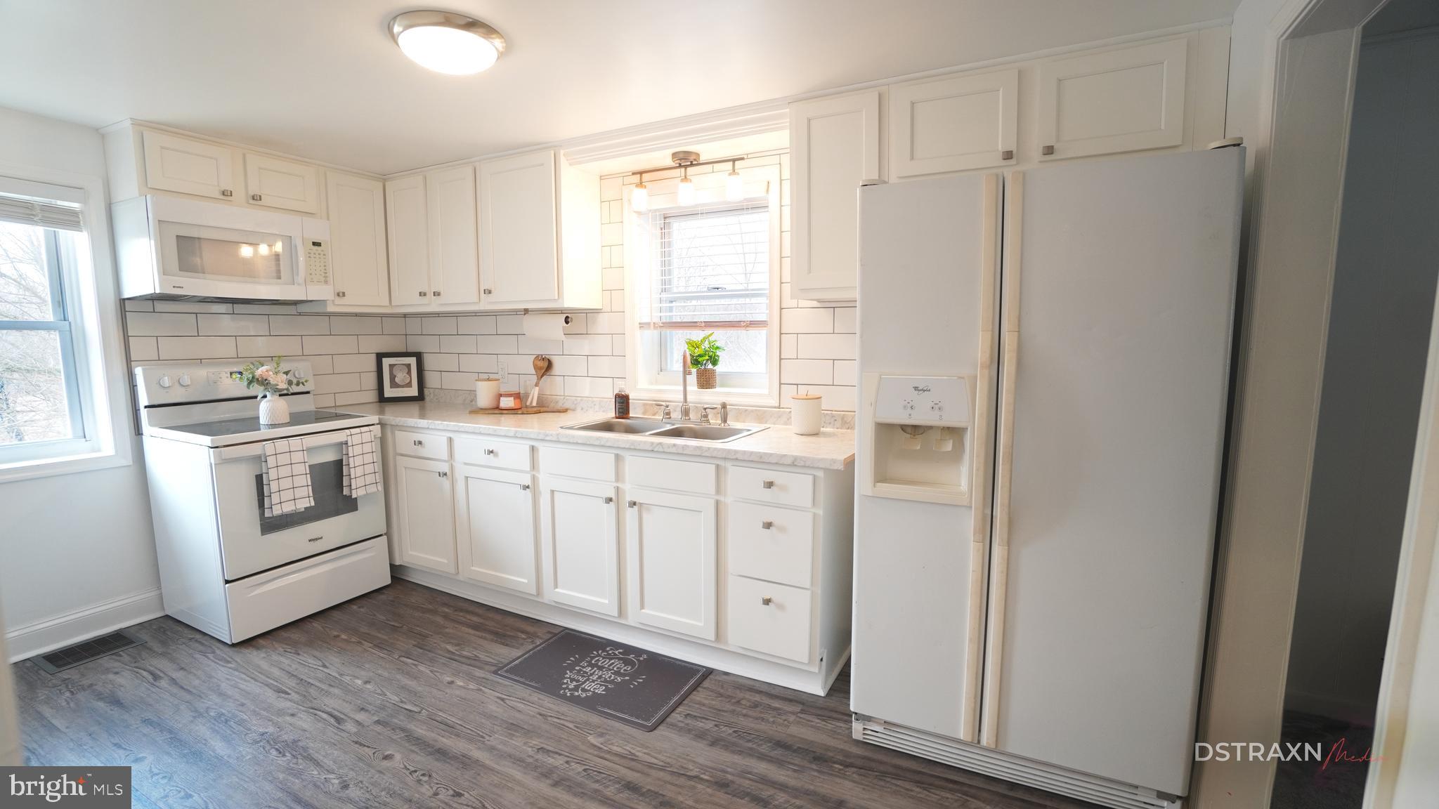 3708 Limekiln Road Sharpsburg, MD 21782 - Photo 8 of 33 a kitchen with white cabinets and white appliances