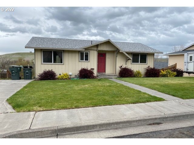 1816 Southwest 45th Street Pendleton, OR 97801 - Photo 1 of 32 a front view of a house with a yard and garage