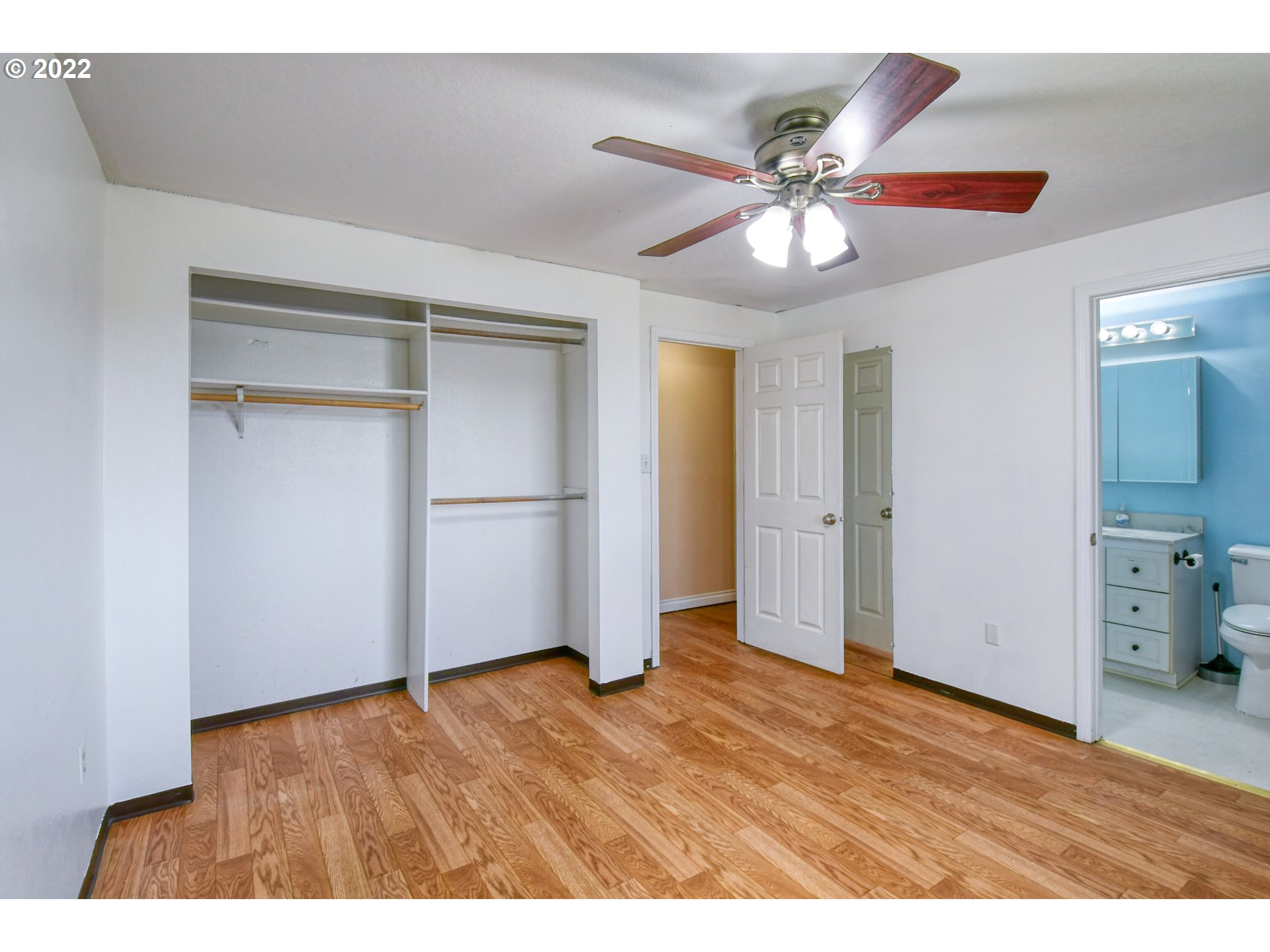 1816 Southwest 45th Street Pendleton, OR 97801 - Photo 12 of 32 a view of an empty room with wooden floor and a ceiling fan
