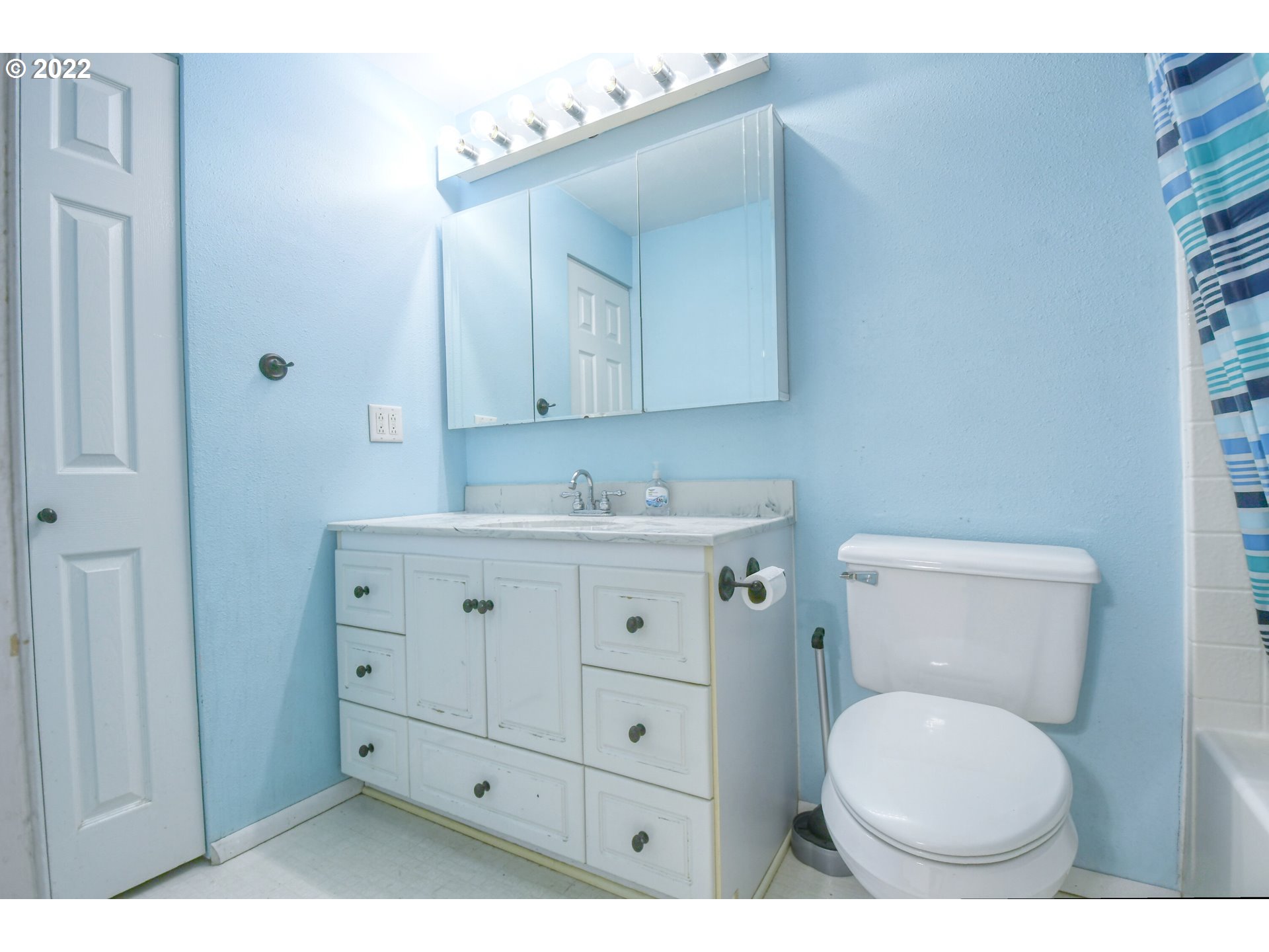 1816 Southwest 45th Street Pendleton, OR 97801 - Photo 13 of 32 a bathroom with a toilet a sink a mirror and vanity
