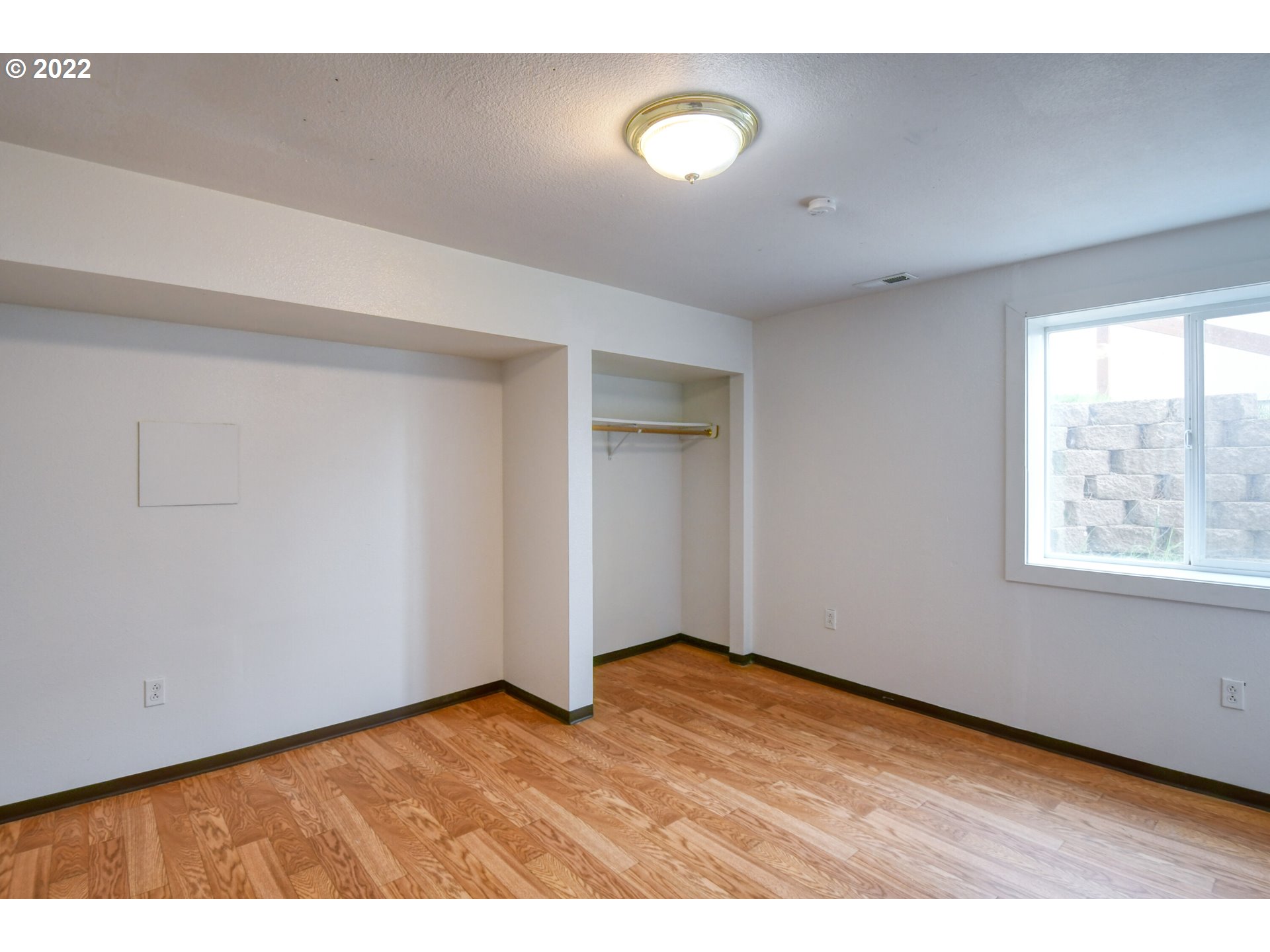1816 Southwest 45th Street Pendleton, OR 97801 - Photo 19 of 32 a view of an empty room with wooden floor and a window
