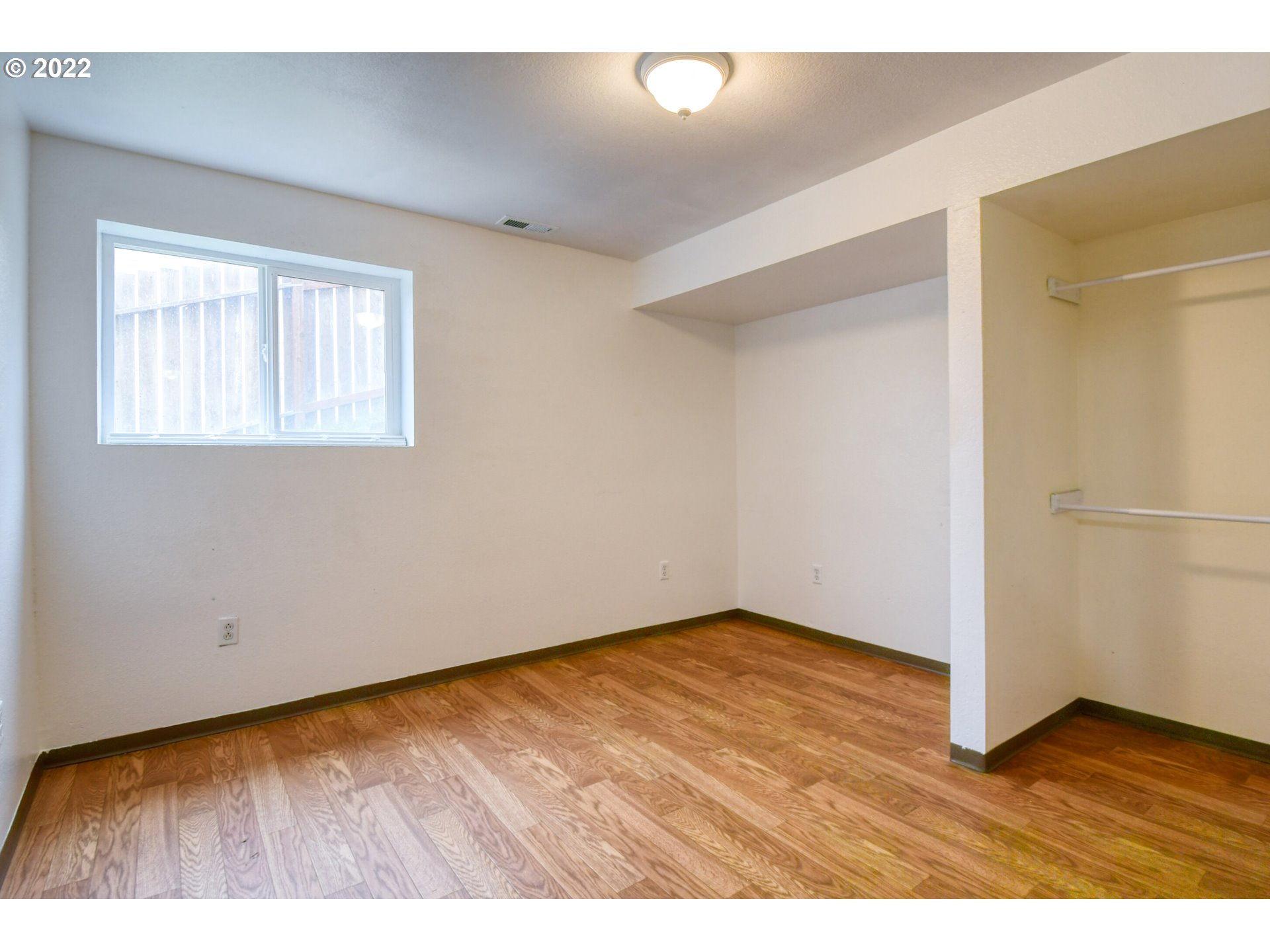1816 Southwest 45th Street Pendleton, OR 97801 - Photo 20 of 32 a view of an empty room with wooden floor and a window