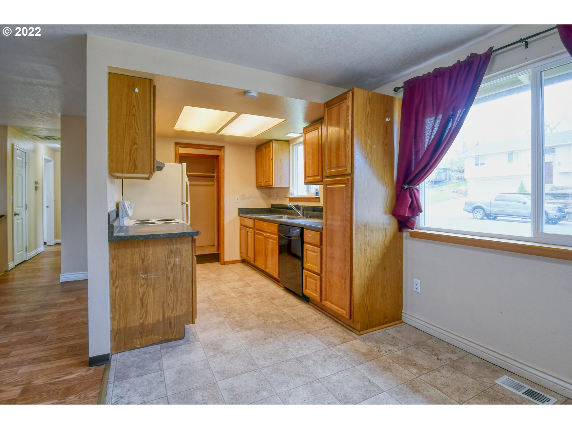 1816 Southwest 45th Street Pendleton, OR 97801 - Photo 7 of 32 a view of a kitchen with an empty room and wooden floor