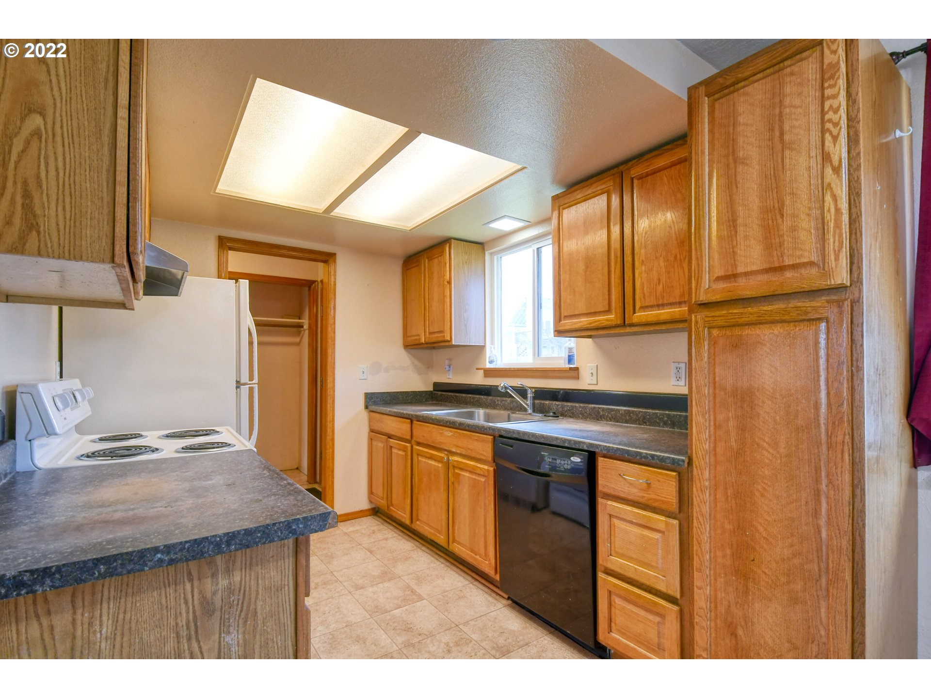 1816 Southwest 45th Street Pendleton, OR 97801 - Photo 8 of 32 a kitchen with kitchen island granite countertop a sink cabinets and stainless steel appliances