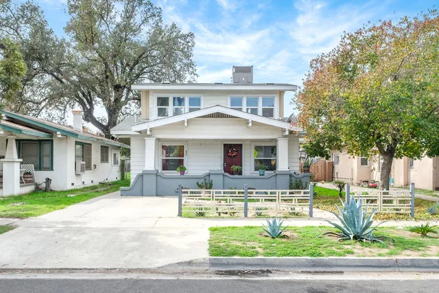 a front view of a house with a yard table and chairs