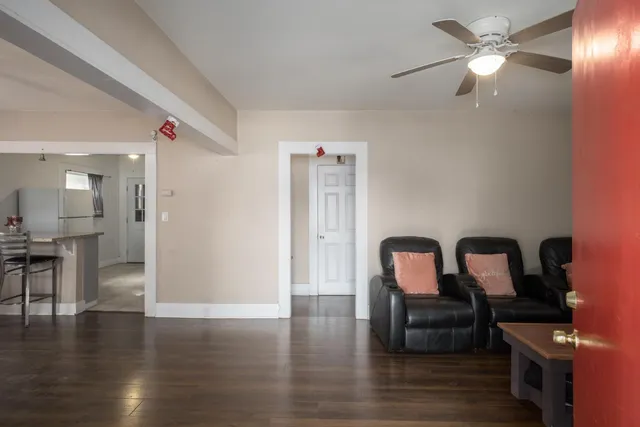 a hallway with furniture and wooden floor