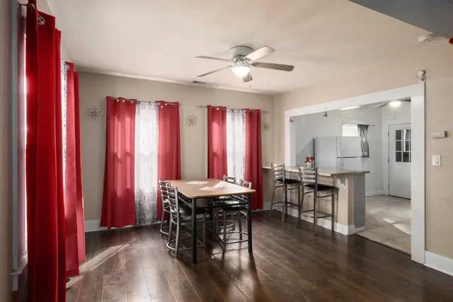 a view of a a dining room with furniture window and wooden floor