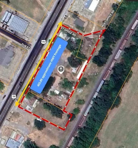 a view of a park with large trees and a barn in it