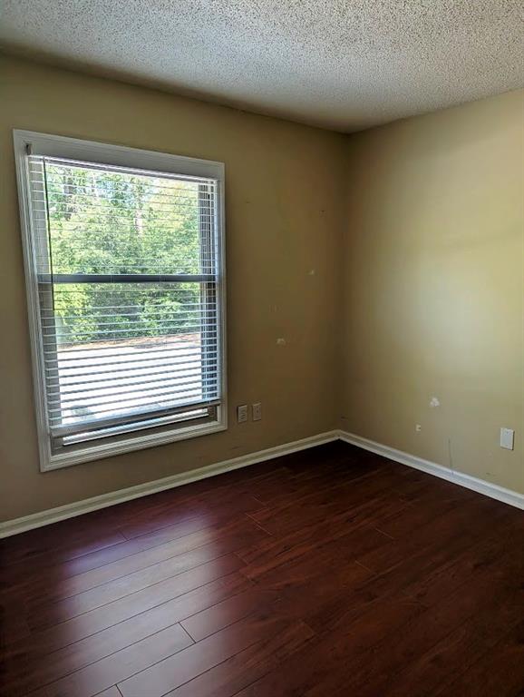3650 Ashford Dunwoody Road Northeast, Unit 918 Atlanta, GA 30319 - Photo 11 of 17 a view of an empty room with wooden floor and a window