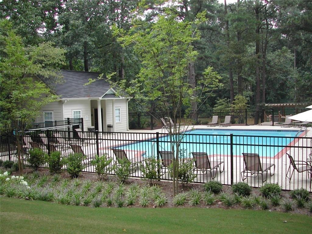 3650 Ashford Dunwoody Road Northeast, Unit 918 Atlanta, GA 30319 - Photo 15 of 17 a front view of a house with a garden