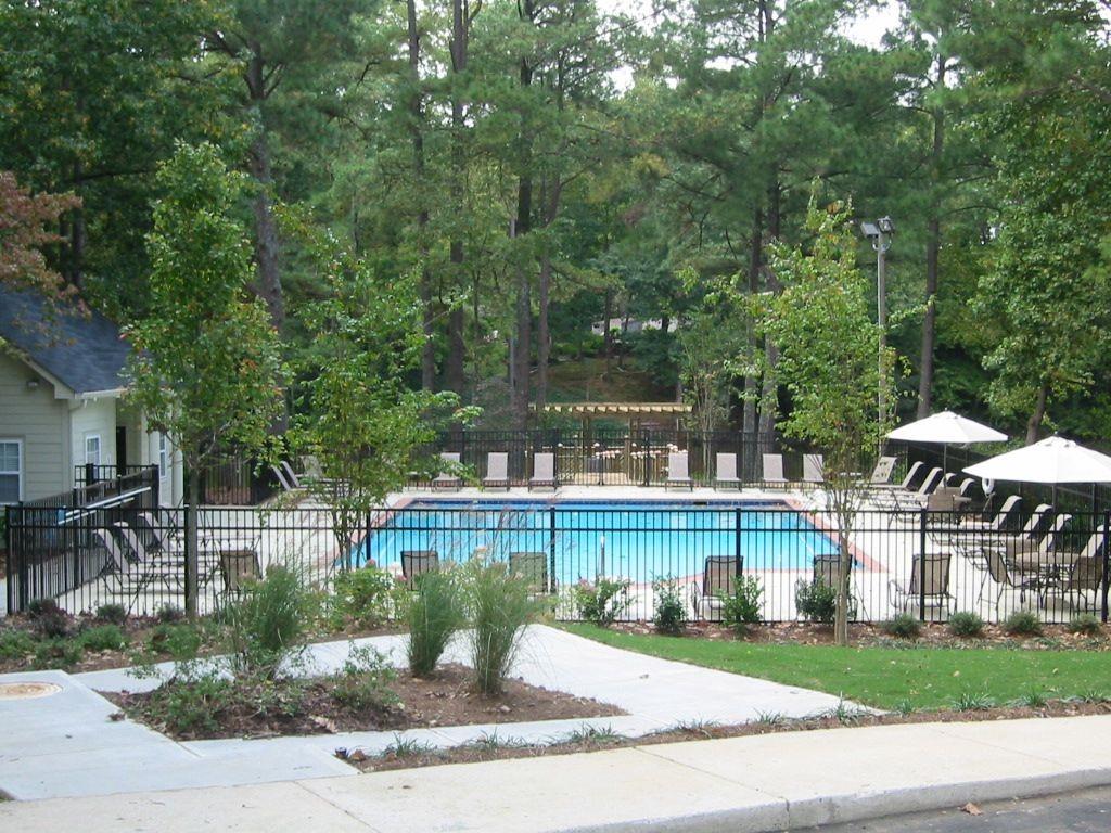 3650 Ashford Dunwoody Road Northeast, Unit 918 Atlanta, GA 30319 - Photo 16 of 17 a view of a lake with a patio and a yard